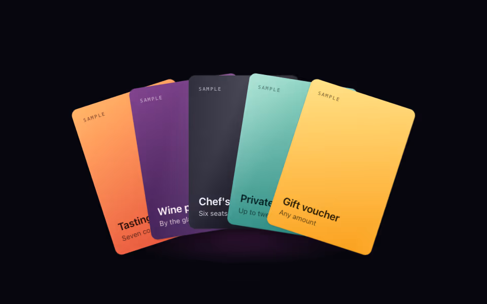A fan of five colourful cards with the middle one lifted