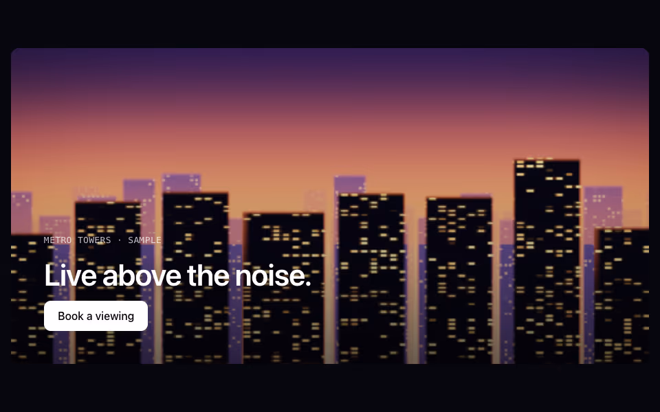 A dusk skyline of lit towers under an orange and violet sky